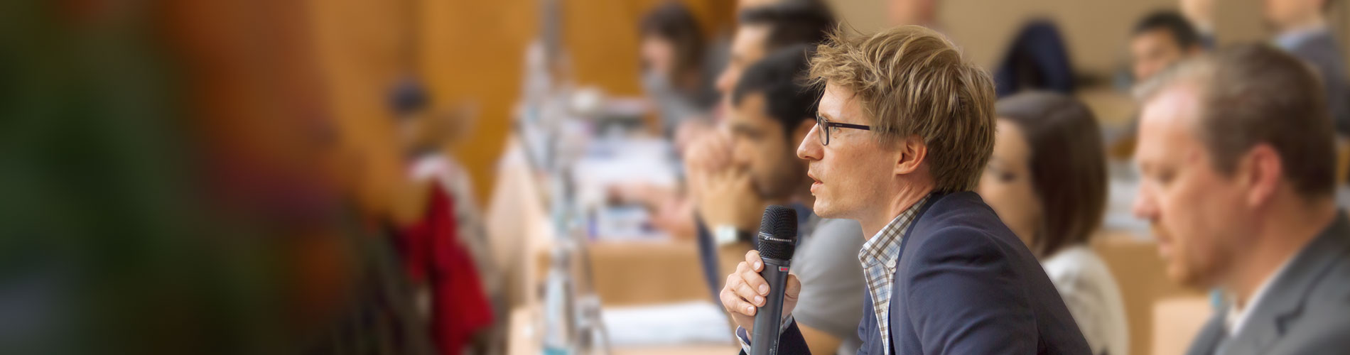 The man at the audience is holding a microphone